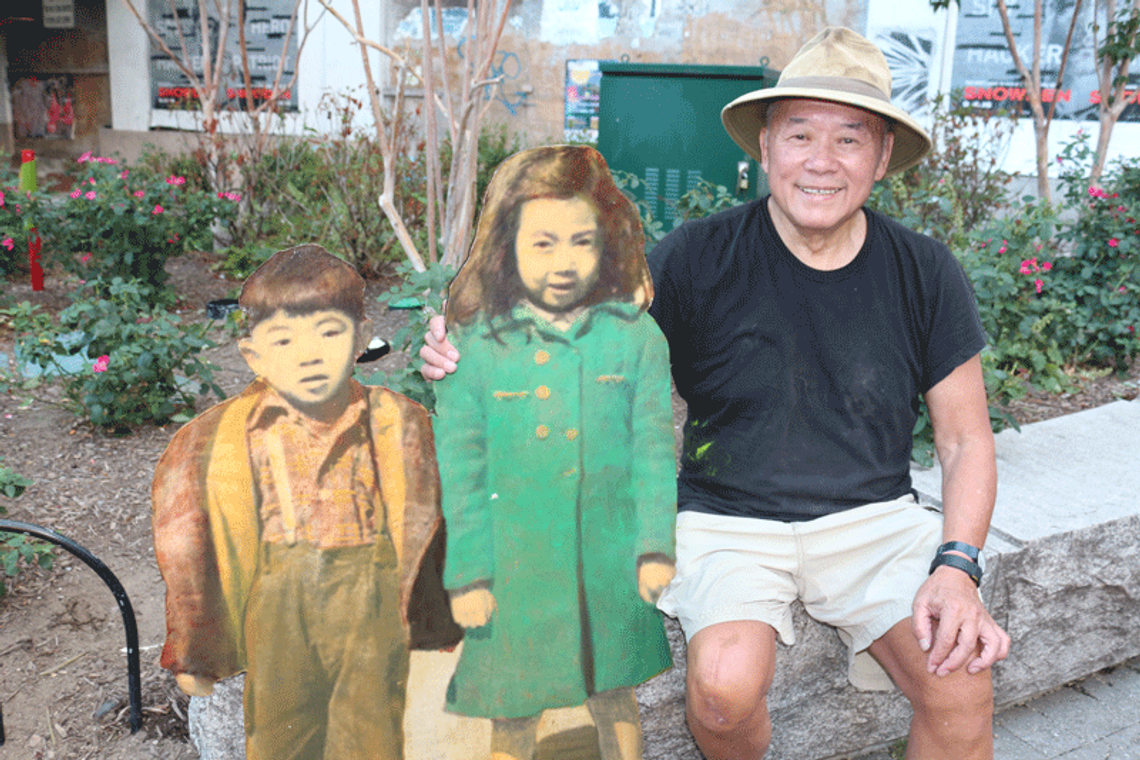Three people sitting on a bench