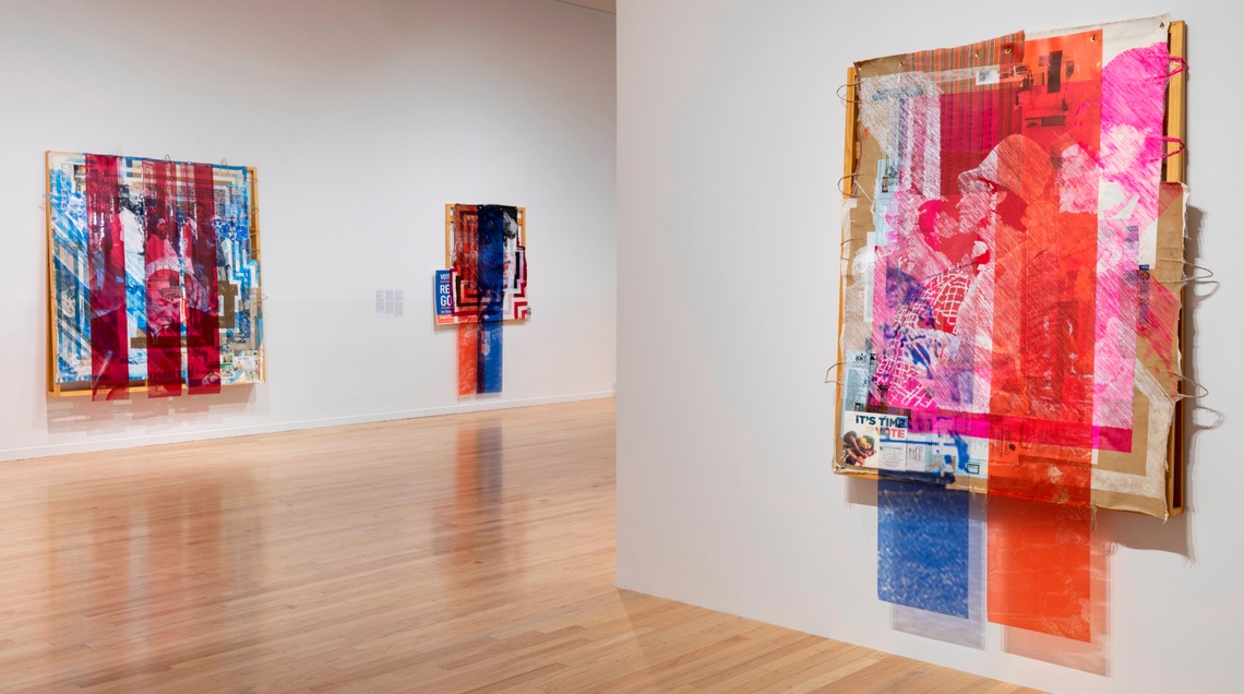 Three large scale Tomashi Jackson works in contrasting cool and warm toned halftone lines hang on the white walls of TUAG / Medford gallery.