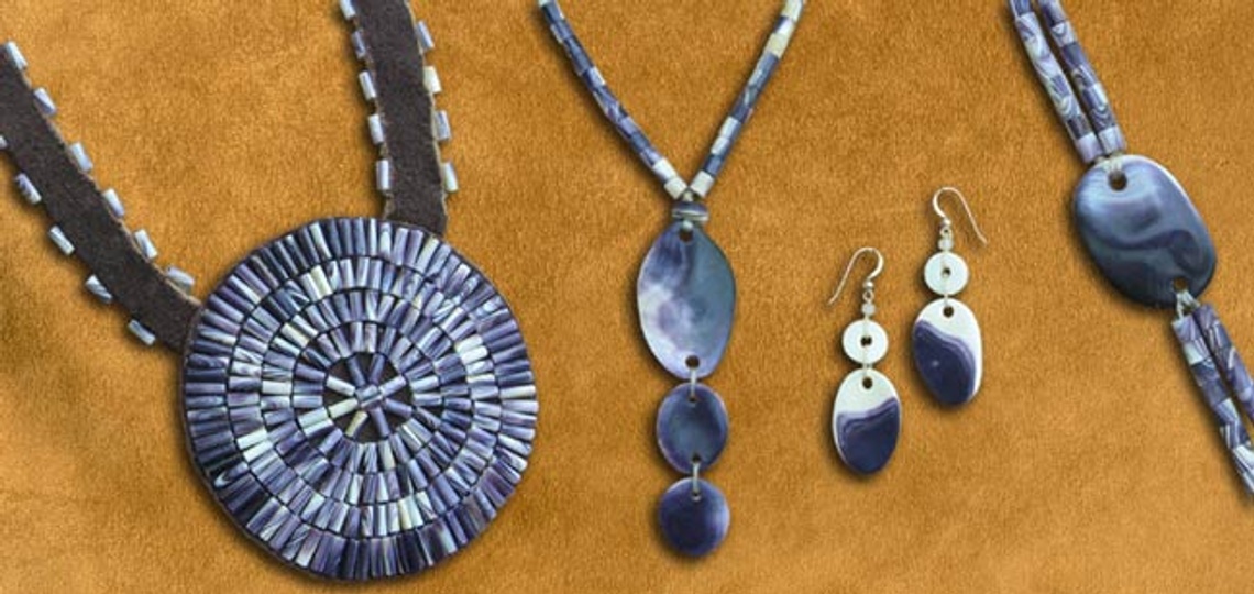 purple and white wampum shell jewelry against brown backdrop