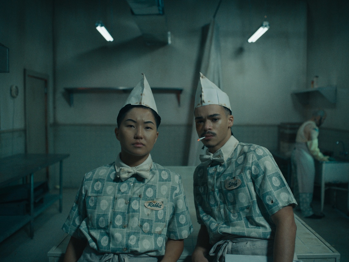 gray washed scene with two people in hats
