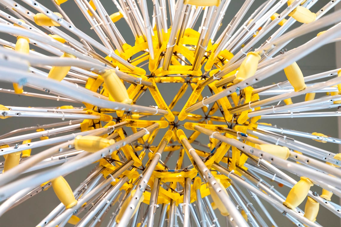 Close-up of yellow crutch handles arranged in a sunburst pattern
